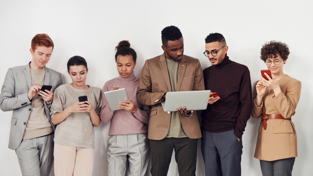 A diverse group of Canadians using personal handheld devices to access the Internet to show that the digital divide is fading.